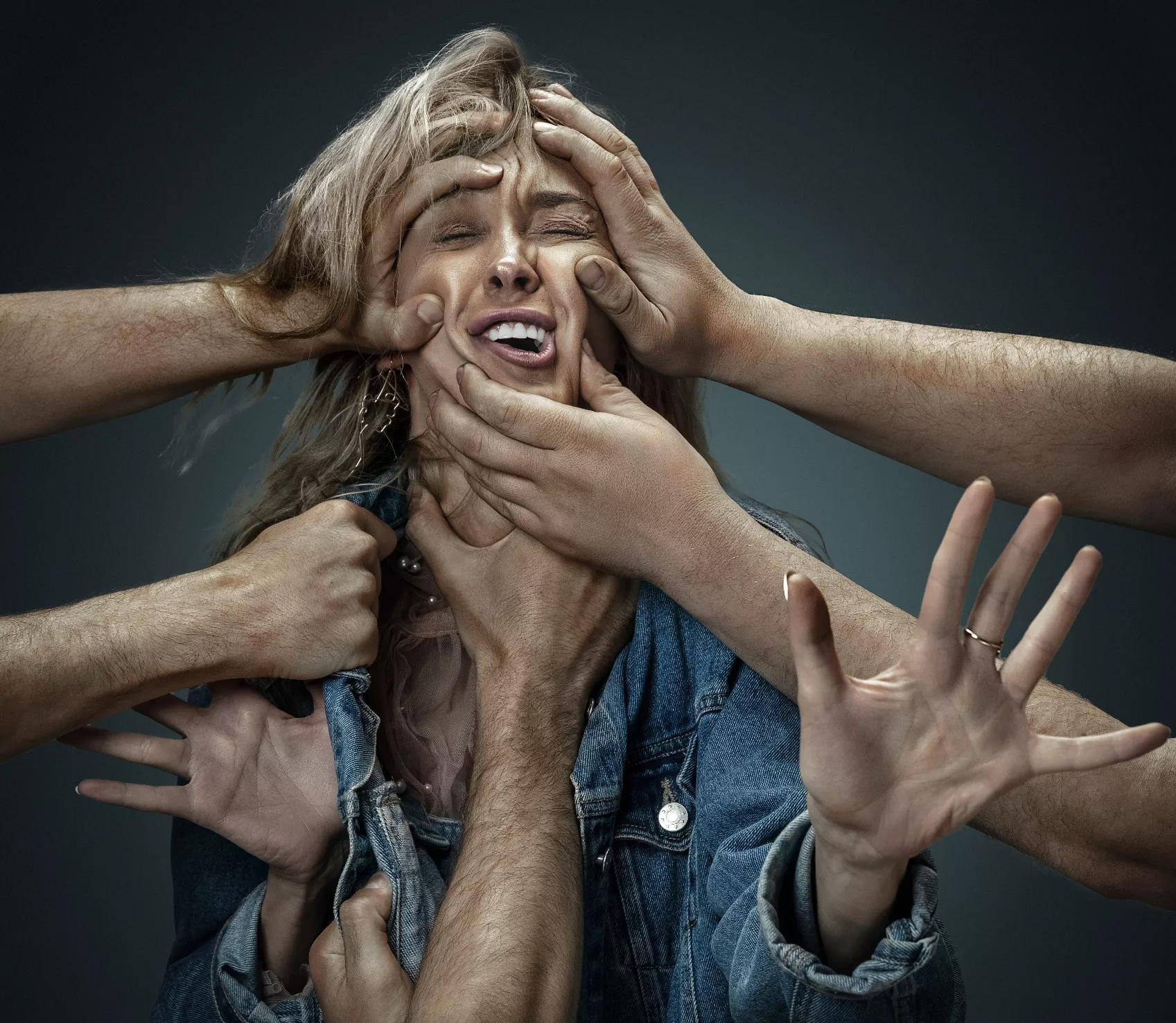 A young woman surrounded by hands like her own thoughts